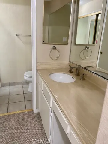 a view of a hallway with a room and a toilet
