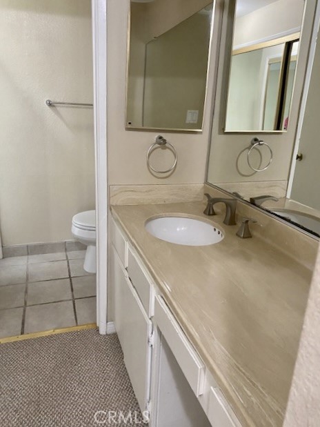 8105 Redlands Street, Unit 107 Playa del Rey, CA 90293 - Photo 7 of 43 a bathroom with a granite countertop sink a toilet and a mirror
