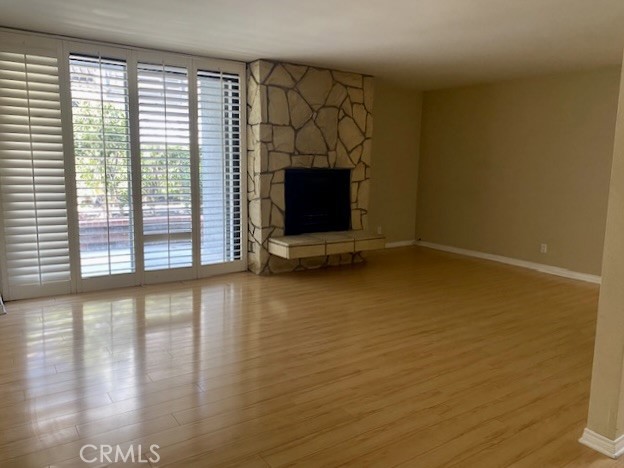 8105 Redlands Street, Unit 107 Playa del Rey, CA 90293 - Photo 9 of 43 a view of a livingroom with wooden floor and a fireplace