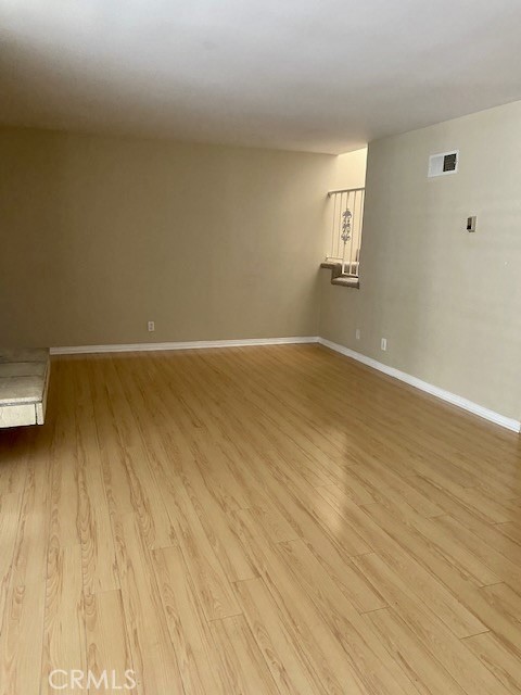 8105 Redlands Street, Unit 107 Playa del Rey, CA 90293 - Photo 10 of 43 an empty room with wooden floor and windows