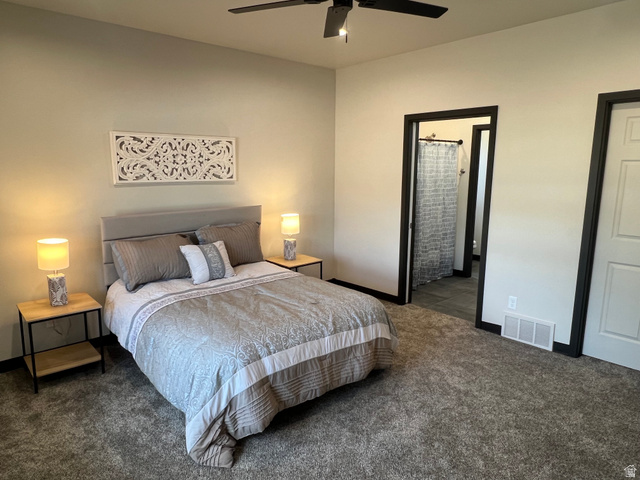 160 200 West Henefer, UT 84033 - Photo 19 of 25 Carpeted bedroom featuring a black ceiling fan, light gray walls, an upholstered headboard, and dark trim around doorways