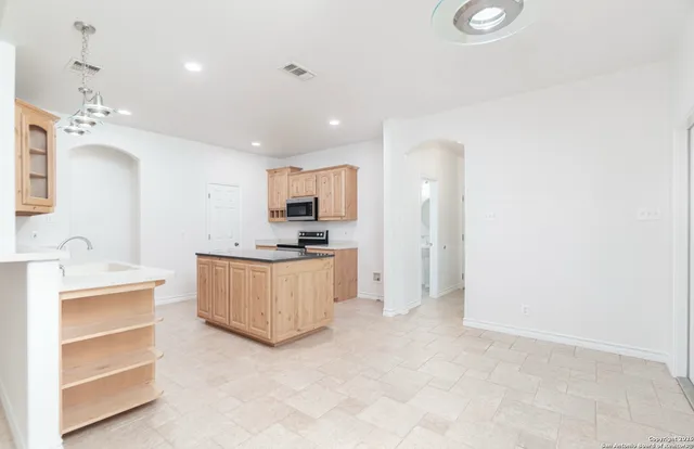 a kitchen with a refrigerator and a sink