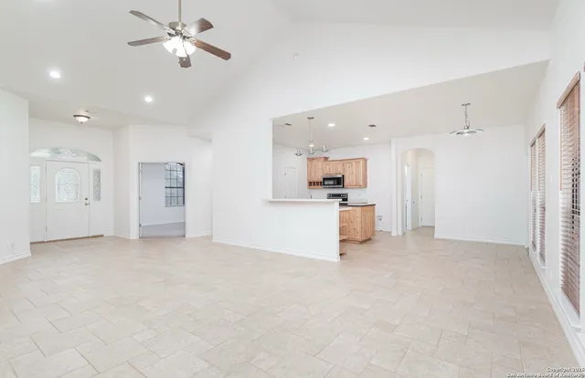 a view of a kitchen with refrigerator and a sink
