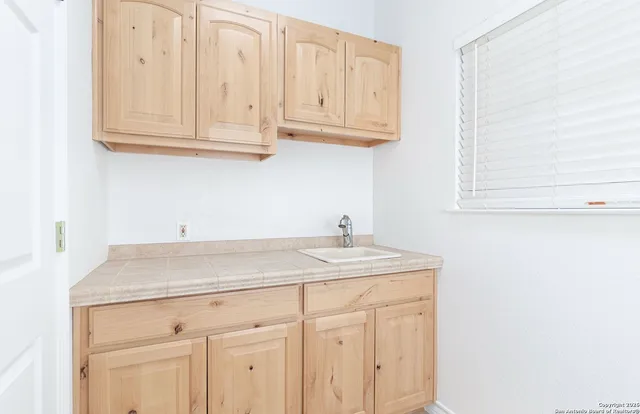 a kitchen with stainless steel appliances granite countertop white cabinets sink and dishwasher