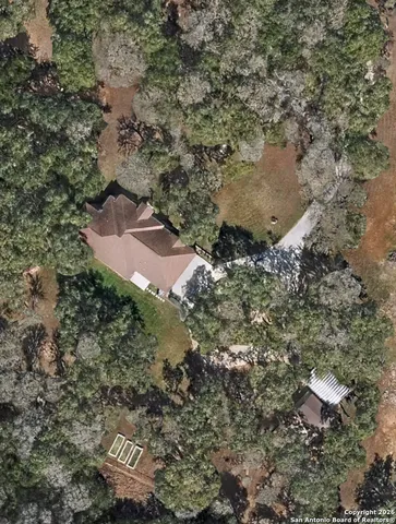 an aerial view of house with yard and mountain view in back