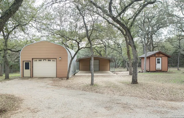 a view of a house with a large tree