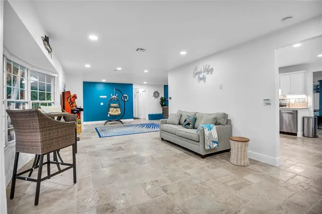 a living room with furniture and kitchen view