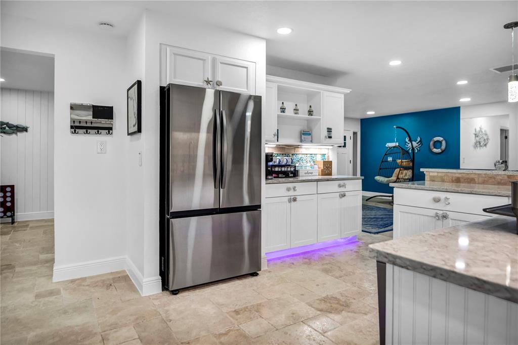 31 Lands End Lane Sarasota, FL 34242 - Photo 15 of 49 a kitchen with granite countertop a refrigerator and a sink