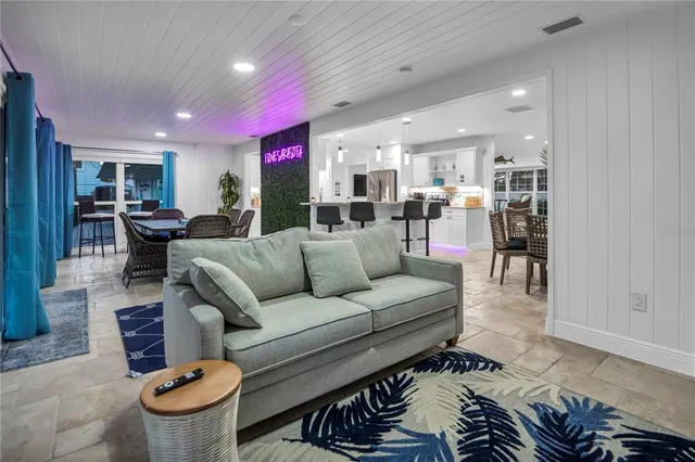 a living room with furniture and a glass door