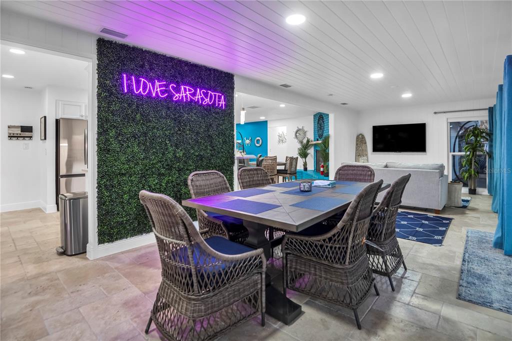31 Lands End Lane Sarasota, FL 34242 - Photo 20 of 49 a dining room with furniture a rug and a floor to ceiling window