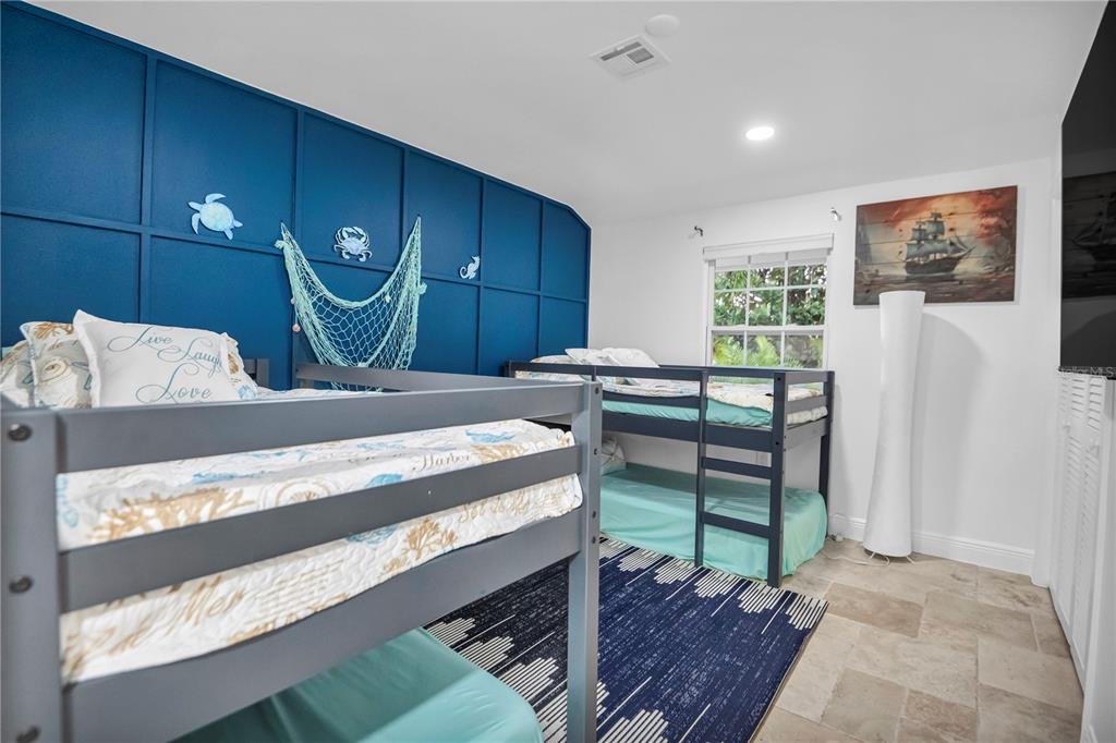 31 Lands End Lane Sarasota, FL 34242 - Photo 23 of 49 a bed room with a bed mirror and a lamp