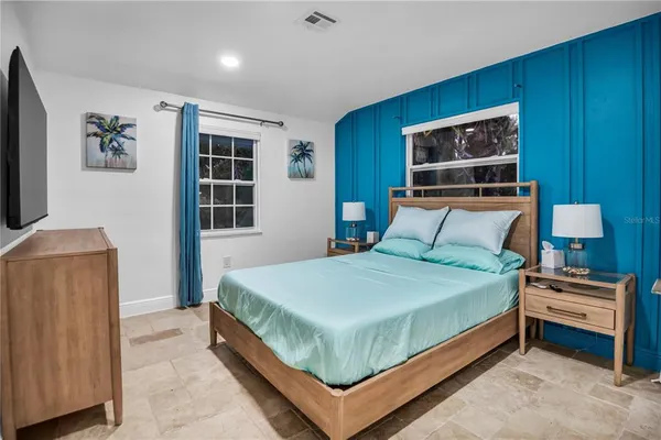 a bedroom with a bed and a television