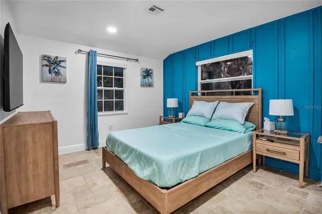 a bedroom with a bed and a television