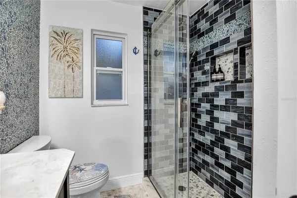 a bathroom with a toilet and a shower