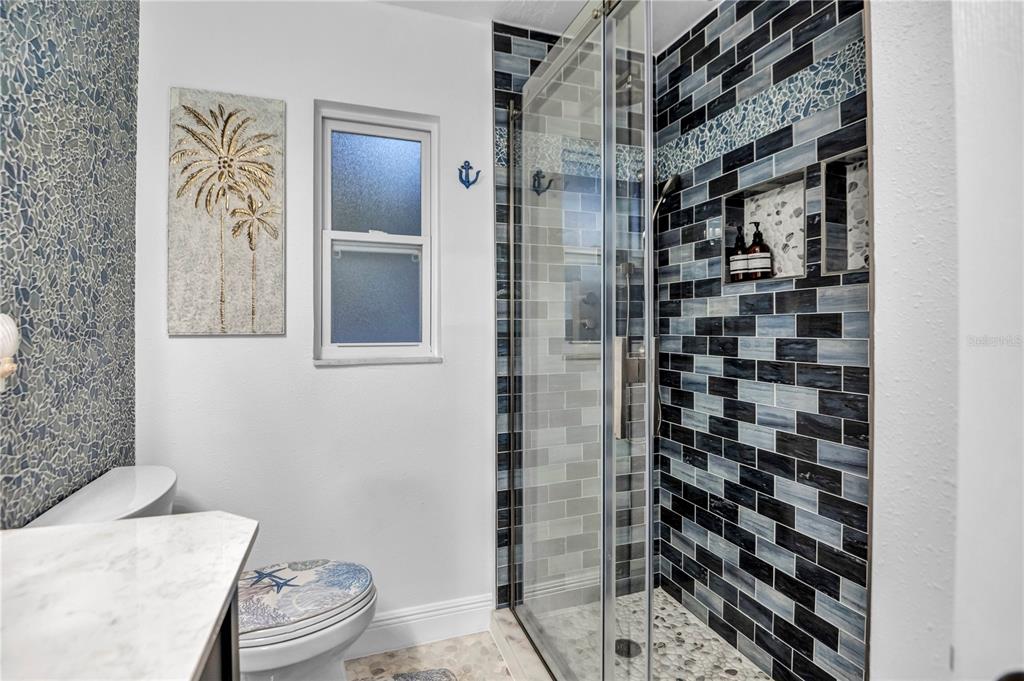 31 Lands End Lane Sarasota, FL 34242 - Photo 28 of 49 a bathroom with a toilet and a shower