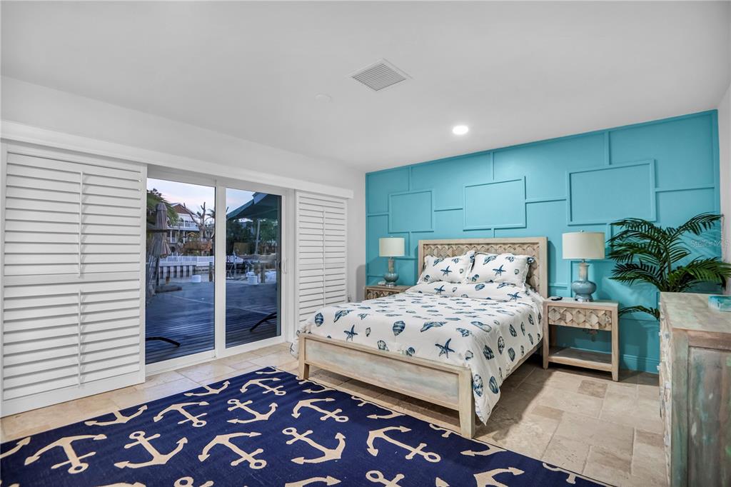 31 Lands End Lane Sarasota, FL 34242 - Photo 29 of 49 a bedroom with a large bed and a potted plant