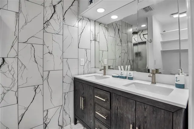 a bathroom with double vanity sink and a mirror