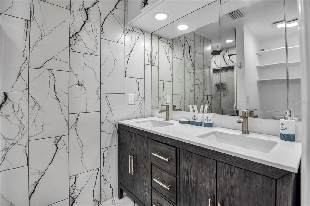 31 Lands End Lane Sarasota, FL 34242 - Photo 31 of 49 a bathroom with double vanity sink and a mirror