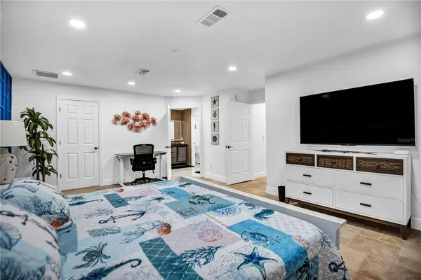 a bedroom with furniture and a flat screen tv