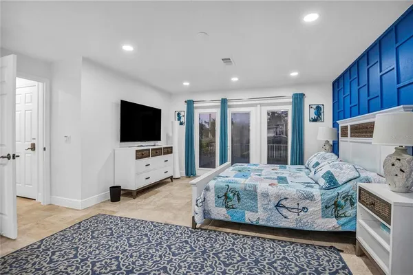 a bedroom with a bed and a flat screen tv