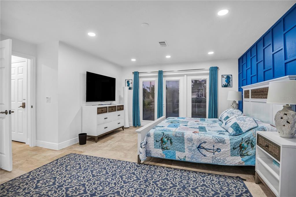 31 Lands End Lane Sarasota, FL 34242 - Photo 35 of 49 a bedroom with a bed and a flat screen tv