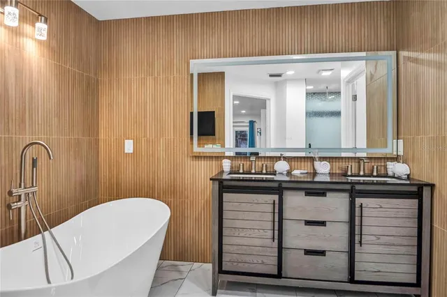 a bathroom with a sink a mirror and a bathtub