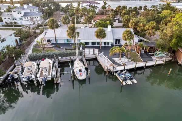 an aerial view of a house with swimming pool and outdoor seating