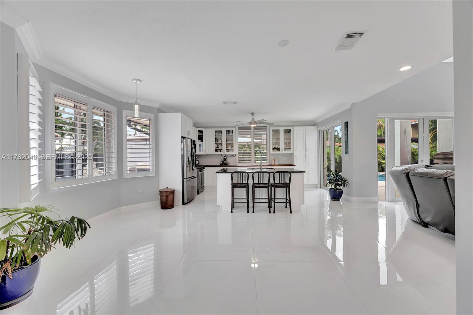 9663 Southwest 158th Court Miami, FL 33196 - Photo 16 of 55 a kitchen with stainless steel appliances kitchen island granite top and refrigerator