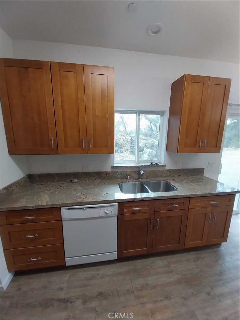 5515 Carleton Road Mariposa, CA 95338 - Photo 5 of 9 a kitchen with stainless steel appliances granite countertop wooden cabinets a sink and a window