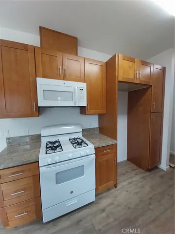 a kitchen with stainless steel appliances granite countertop cabinets and window