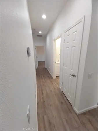 a view of a hallway with wooden floor