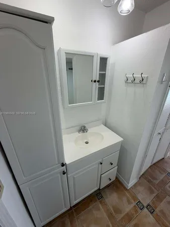 a bathroom with a sink a mirror and vanity