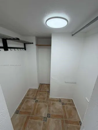 a view of a room with a sink and cabinets