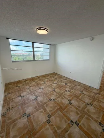 a view of a room with wooden floor and white walls