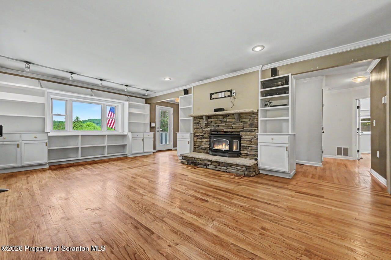 457 Craig Road Dalton, PA 18414 - Photo 20 of 114 a view of empty room with wooden floor and fireplace