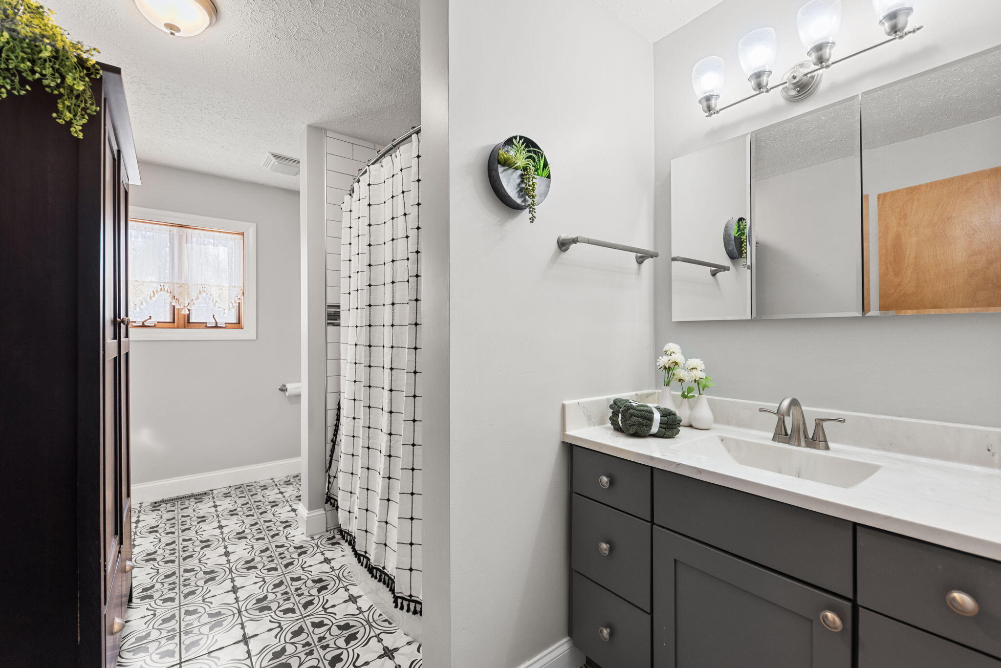 6613 West 86th Court Crown Point, IN 46307 - Photo 13 of 23 a bathroom with a sink a mirror a vanity and shower