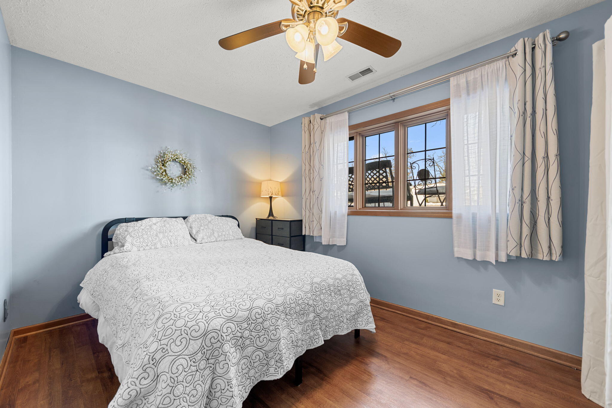 6613 West 86th Court Crown Point, IN 46307 - Photo 18 of 23 a bedroom with a large bed and a chandelier