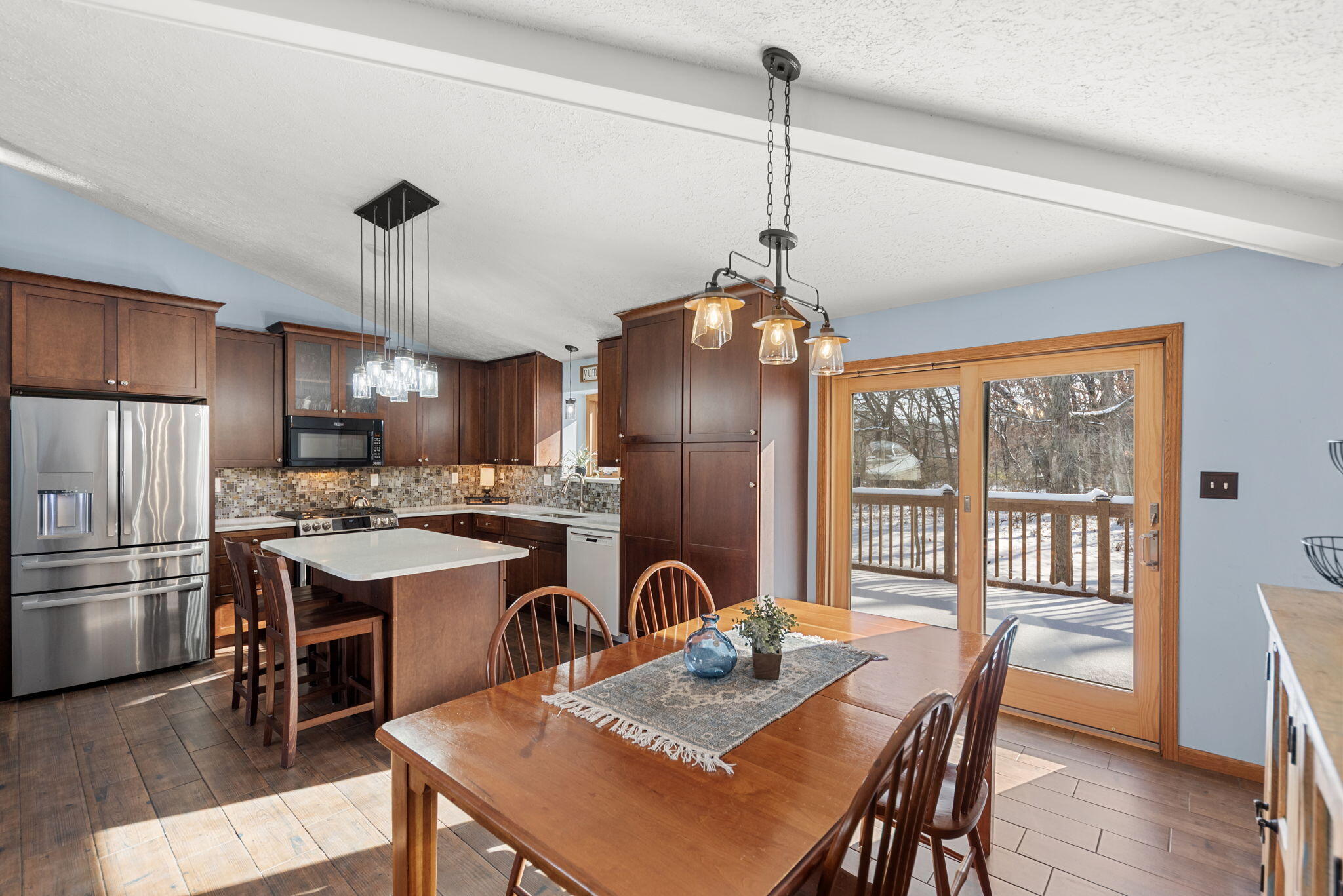 6613 West 86th Court Crown Point, IN 46307 - Photo 6 of 23 a kitchen with stainless steel appliances granite countertop a stove a refrigerator a kitchen island a dining table and chairs