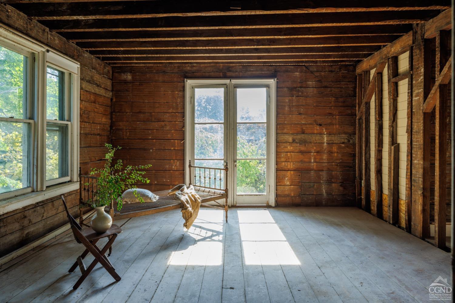 a view of a porch with wooden floor and a potted plant