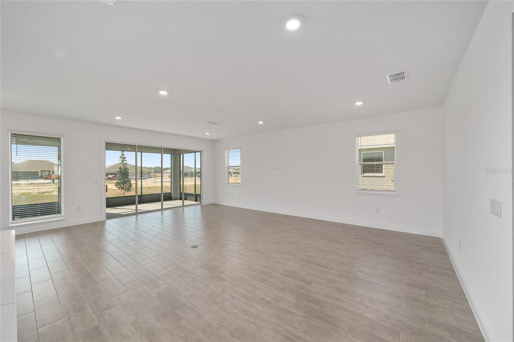 10104 Southwest 106th Circle Ocala, FL 34481 - Photo 11 of 47 an empty room with wooden floor and windows