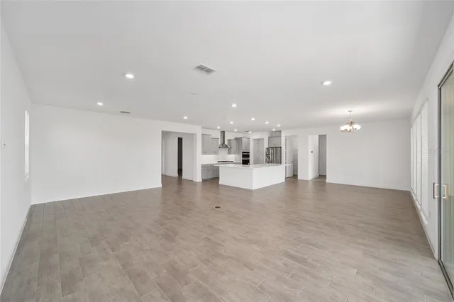 a view of kitchen with kitchen island and living room