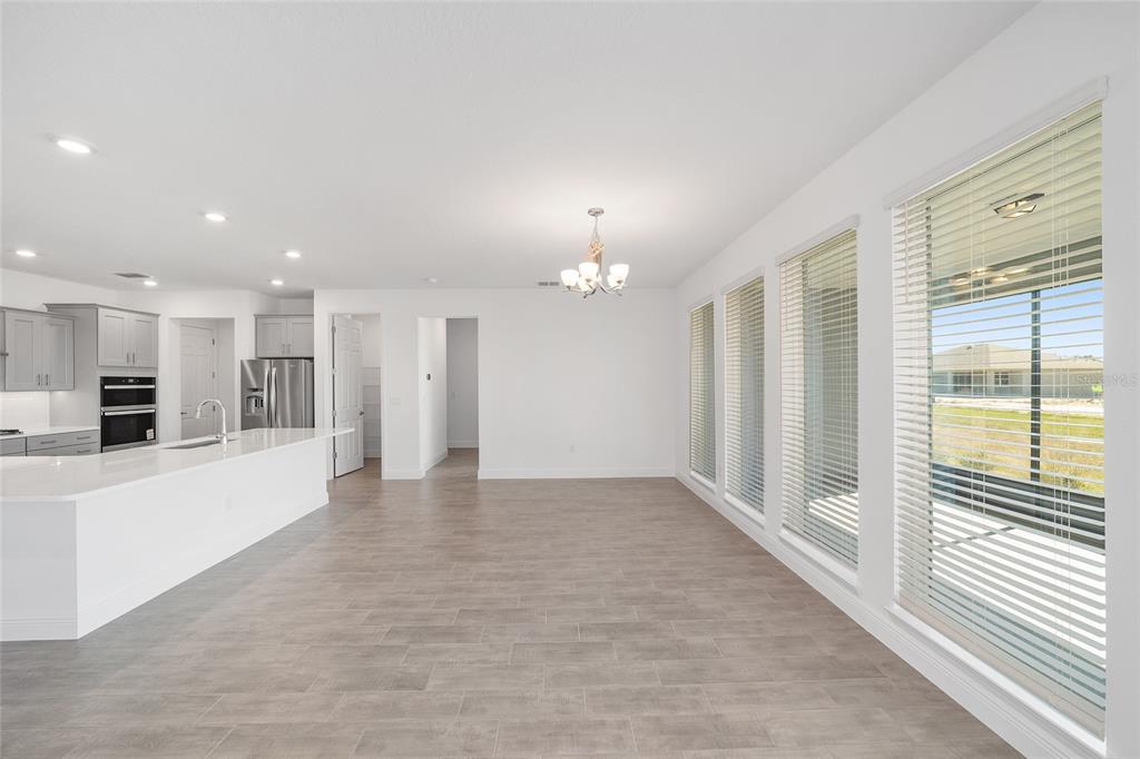 10104 Southwest 106th Circle Ocala, FL 34481 - Photo 15 of 47 a view of an empty room with kitchen view and a window