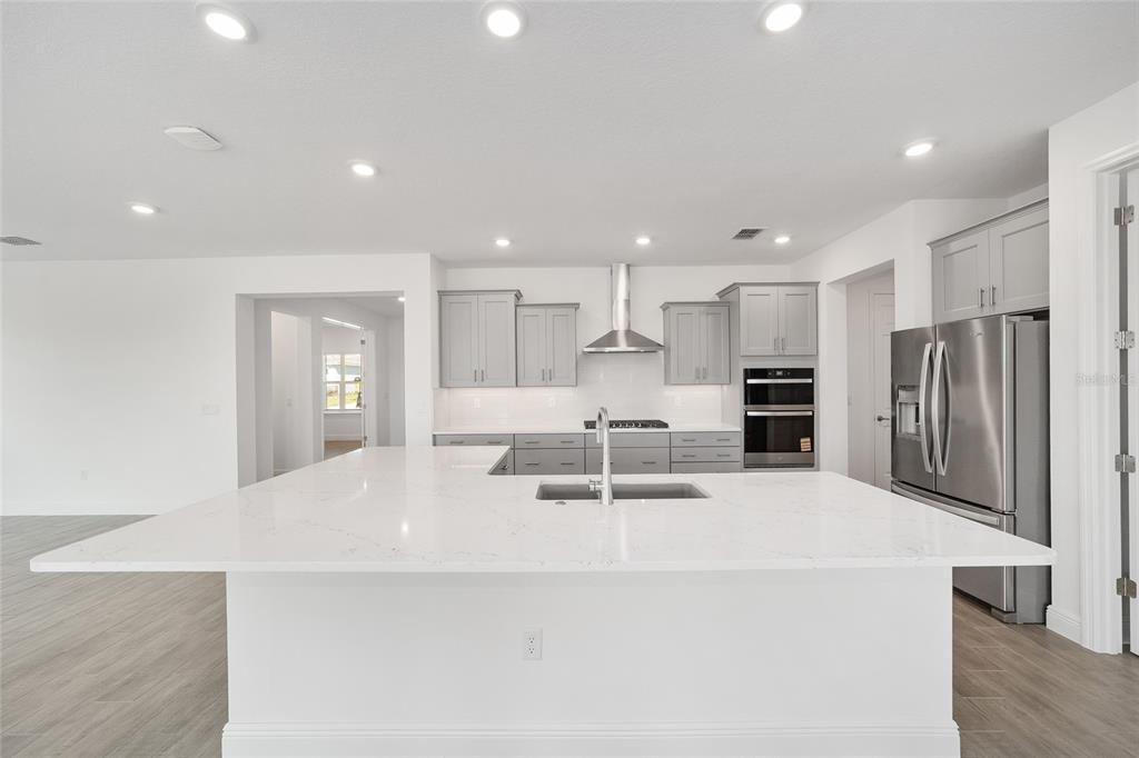 10104 Southwest 106th Circle Ocala, FL 34481 - Photo 18 of 47 a large white kitchen with a refrigerator a oven and a sink
