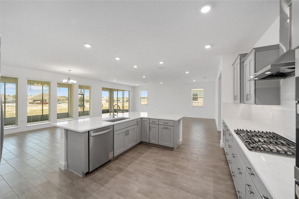 10104 Southwest 106th Circle Ocala, FL 34481 - Photo 22 of 47 a large kitchen with stainless steel appliances granite countertop a large stove top oven and cabinets