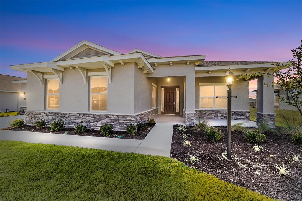 10104 Southwest 106th Circle Ocala, FL 34481 - Photo 3 of 47 a front view of a house with a yard