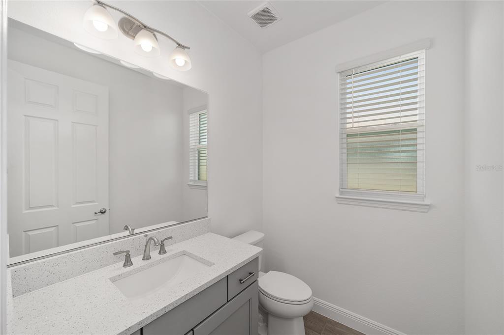 10104 Southwest 106th Circle Ocala, FL 34481 - Photo 38 of 47 a bathroom with a sink a toilet and a mirror
