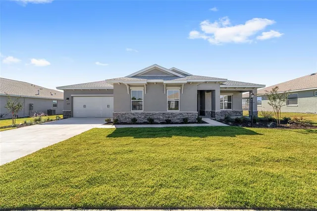 a view of a house with swimming pool and a yard