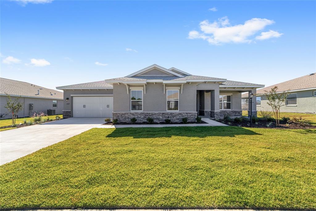 10104 Southwest 106th Circle Ocala, FL 34481 - Photo 4 of 47 a view of a house with swimming pool and a yard