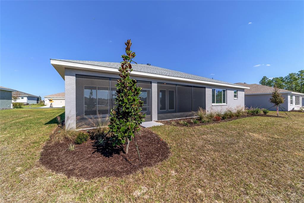 10104 Southwest 106th Circle Ocala, FL 34481 - Photo 45 of 47 a view of a house with backyard and garden