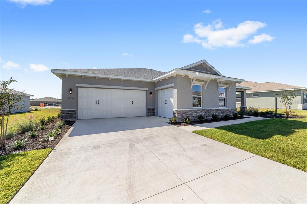 10104 Southwest 106th Circle Ocala, FL 34481 - Photo 5 of 47 a front view of a house with a yard and garage